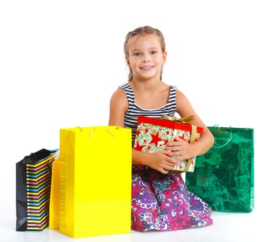 Shopping little girl happy smiling holding shopping bags isolated on white background.