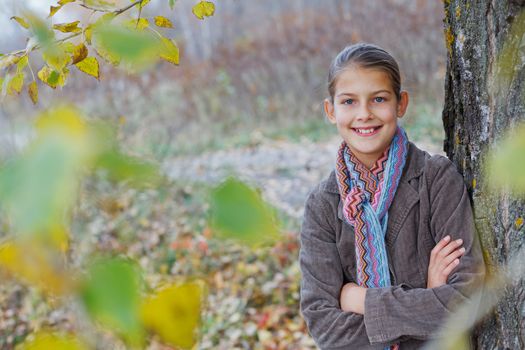 Portrait of beautiful girl walking in a autumn park