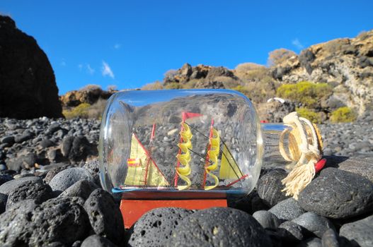 Ancient Spanish Sailing Boat in a Bottle near the Ocean