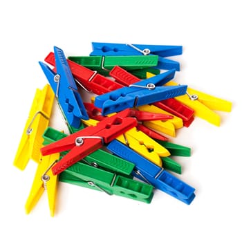 Closeup image of little colorful office clothespins isolated on a white background