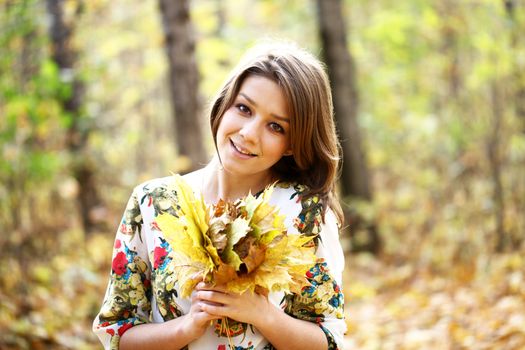 Portrait of beautiful woman in autumn park