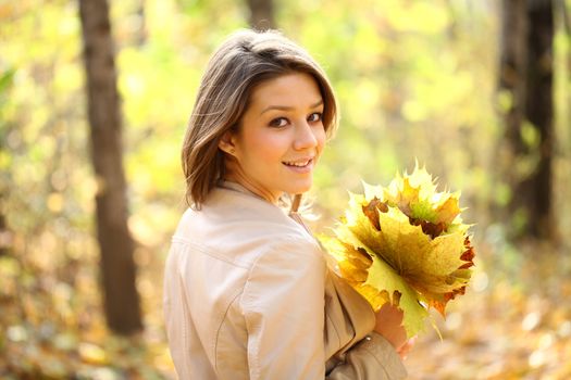 Portrait of beautiful woman in autumn park