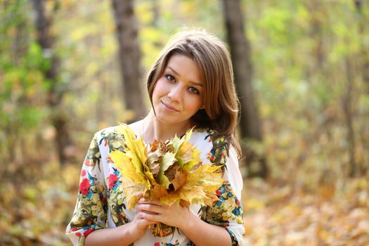 Portrait of beautiful woman in autumn park