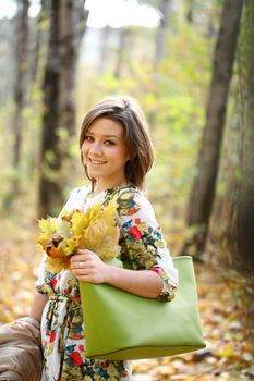 Beautiful young woman in autumn park