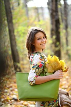 Beautiful young woman in autumn park