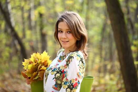 Portrait of beautiful woman in autumn park