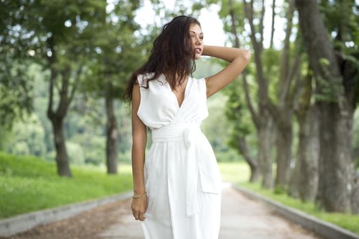 Happy woman in a white dress on the street