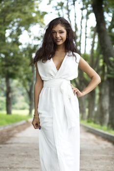 Happy woman in a white dress on the street