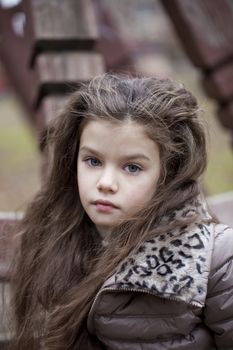 Autumn portrait of a beautiful young girl on the street