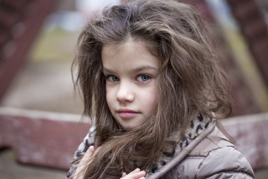 Autumn portrait of a beautiful young girl on the street
