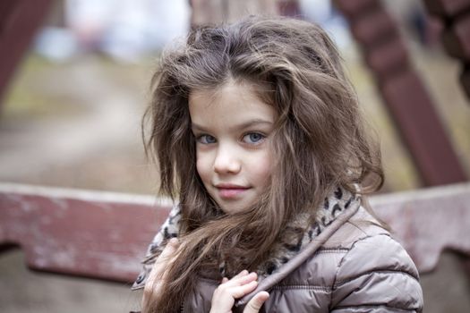 Autumn portrait of a beautiful young girl on the street