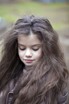 Autumn portrait of a beautiful young girl on the street