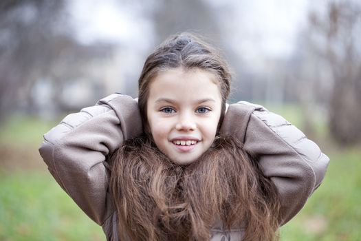 Autumn portrait of a beautiful young girl on the street