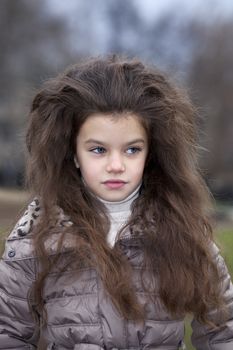 Autumn portrait of a beautiful young girl on the street