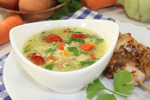 a chicken soup with egg and parsley