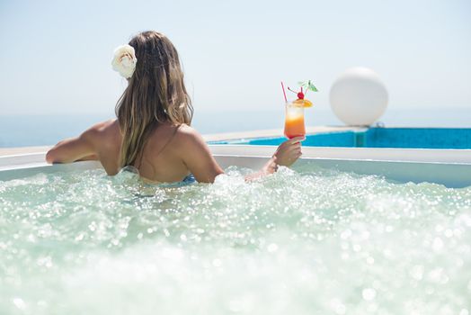 Woman drinking tropical cocktail at  beach resort