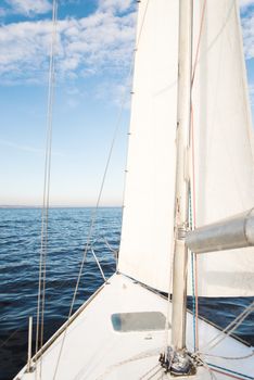 The white yacht sailing towards the sunset