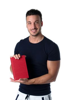 Smiling young man holding and showing book cover and looking in camera