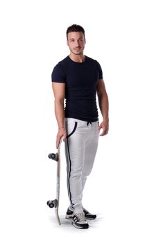 Full figure shot of handsome, smiling young man with skateboard, isolated on white