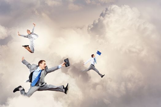 Image of happy business people jumping high in sky