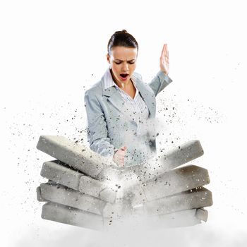 Image of businesswoman breaking bricks with hand