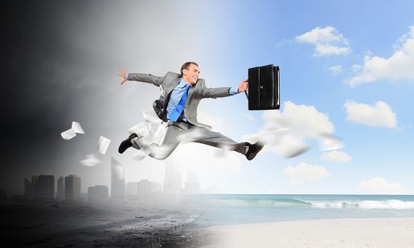 Image of businessman running away from office work