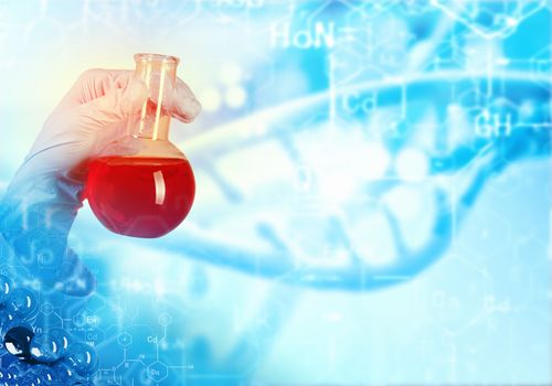 Close up image of human hand holding test tube. Science concept