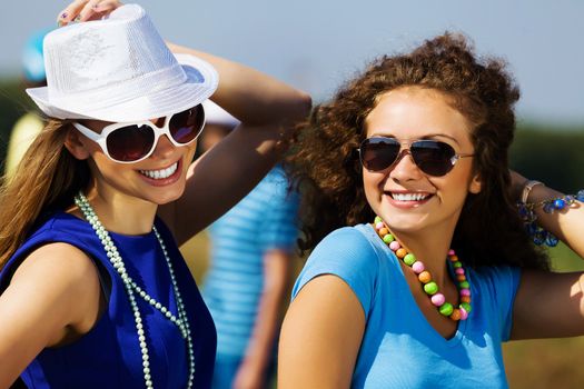 Attractive young women having fun outdoors. Summer vacation