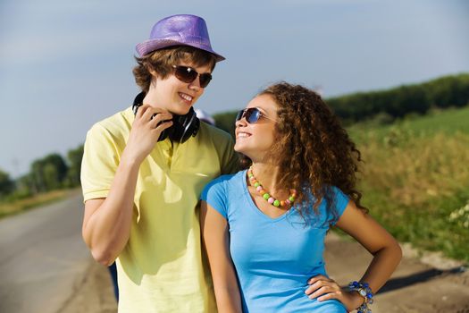 Young man and young woman outdoors. Summer vacation