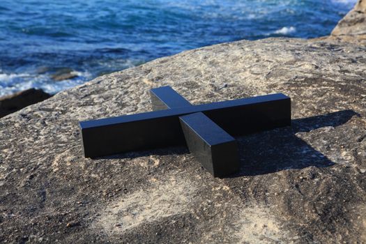 Bondi Beach, Australia - November 3,  2013: Sculpture By The Sea, Bondi 2013. Annual cultural event that showcases emerging artists from around the world  Sculpture titled Xt' by Gill Gatfield (New Zealand).  Medium black granite.  Price $515000