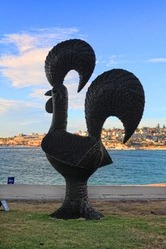 Bondi Beach, Australia - November 3,  2013: Sculpture By The Sea, Bondi 2013. Annual cultural event that showcases emerging artists from around the world  Sculpture titled 'Chicken Cafreal 2012' by Subodh Kerkar (India).  Medium rubber tyres, fibreglass.  Price $12000