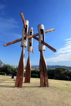 Bondi Beach, Australia - November 3,  2013: Sculpture By The Sea, Bondi 2013. Annual cultural event that showcases emerging artists from around the world  Sculpture titled 'Fallout' by Stephen King (NSW).  Medium stringybark.  Price $50000