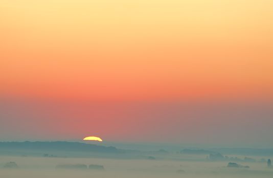 sunset on misty countryside
