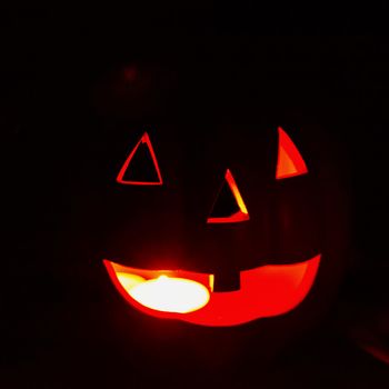 Lights of Jack-o-Lantern shining in the darkness