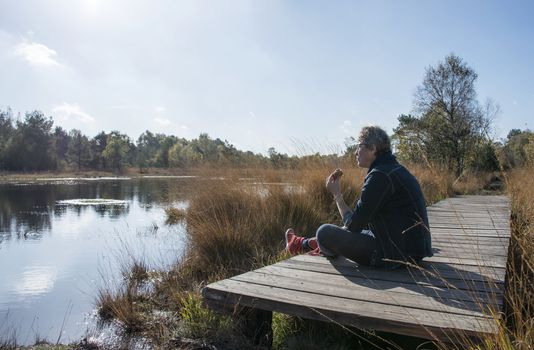 woman relax and using lunch at the gilderhauser venn nature area