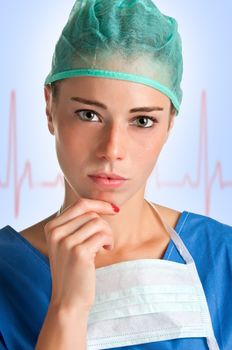 Young female surgeon with scrubs, thinking, with an EKG graph behing her