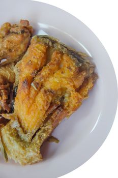 close up  fried fish  on dish over white background