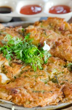 close up omelet and  fresh vegetable served with sauce