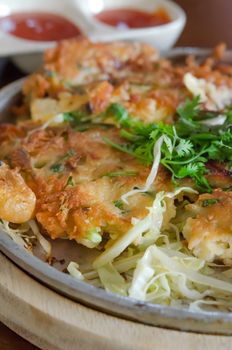 close up of crispy omelet and  fresh vegetable served with tomato sauce 