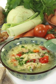 a chicken soup with egg and parsley