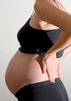 pregnancy back pain with woman holding back