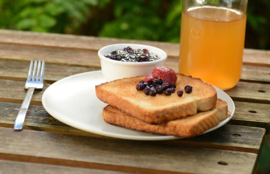 berry toast with jam and apple juice