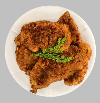 Thicken chops on the white plate. Isolated on the gray background.
