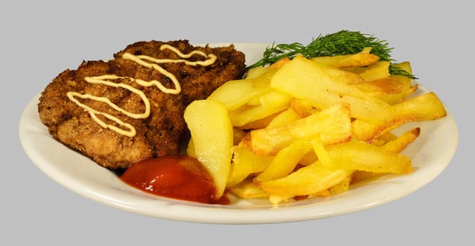 French fries with chicken chops on the white plate. Isolaten on the gray background.