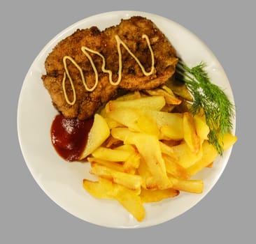 French fries with chicken chops on the white plate. Isolaten on the gray background.
