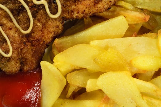 French fries with chicken chops. Close-up view.