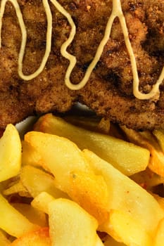 French fries with chicken chops. Close-up view.