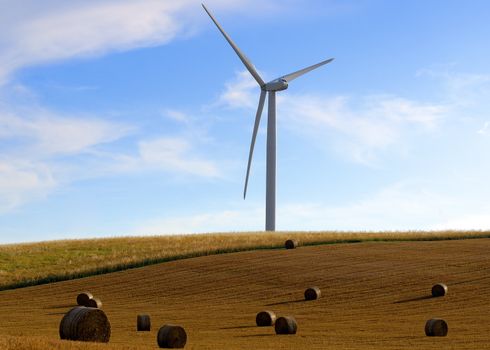 straw bales on wind turbines background