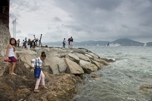 Tourists on Embankment in Saint-Tropez in autumn day