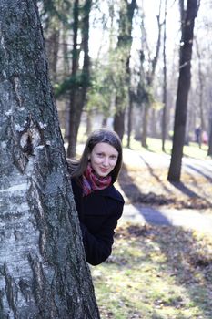 beautiful girl in a park on an autumn-day